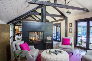 Inspiration for a large contemporary formal and open concept light wood floor living room remodel in Los Angeles with beige walls and a two-sided fireplace