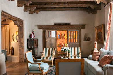 Example of a large tuscan formal and enclosed dark wood floor living room design in Albuquerque with beige walls, no tv and no fireplace