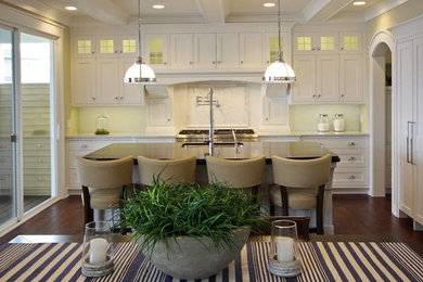 Elegant kitchen photo in Grand Rapids with an undermount sink, shaker cabinets, white cabinets, solid surface countertops and paneled appliances
