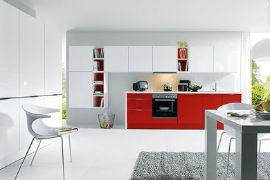 Inspiration for a medium sized modern l-shaped kitchen/diner in Surrey with white cabinets, flat-panel cabinets and no island.