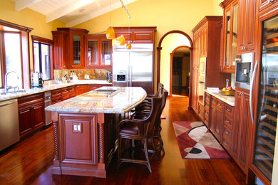 Inspiration for a traditional galley eat-in kitchen in San Francisco with an integrated sink, dark wood cabinets, wood benchtops, brown splashback, terra-cotta splashback, medium hardwood floors and with island.