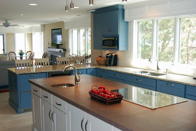 Inspiration for a large coastal u-shaped ceramic tile eat-in kitchen remodel in Baltimore with an island, an undermount sink, shaker cabinets, stainless steel appliances, blue cabinets and granite countertops