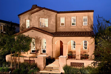 Inspiration for a mid-sized traditional two-storey stucco beige exterior in Orange County.