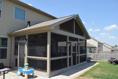 Large classic tile screened-in back porch idea in Charlotte with a roof extension
