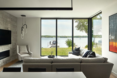 Small minimalist l-shaped medium tone wood floor and brown floor eat-in kitchen photo in Minneapolis with an undermount sink, flat-panel cabinets, black cabinets, quartz countertops, black backsplash, quartz backsplash, paneled appliances, an island and white countertops