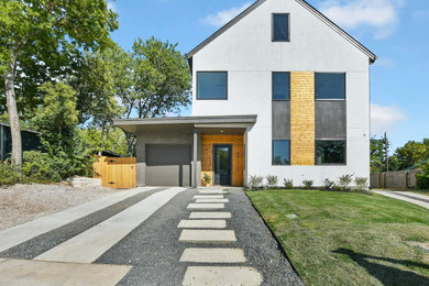 Mid-sized minimalist white three-story stucco and clapboard exterior home photo in Austin with a mixed material roof and a black roof