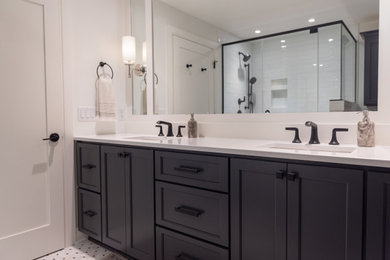 Inspiration for a mid-sized transitional master white tile and subway tile mosaic tile floor, multicolored floor and double-sink corner shower remodel in Other with black cabinets, a two-piece toilet, white walls, quartz countertops, a hinged shower door, white countertops, a niche, a built-in vanity and shaker cabinets