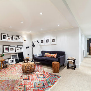 Photo of a small contemporary open plan home cinema in London with white walls and carpet.