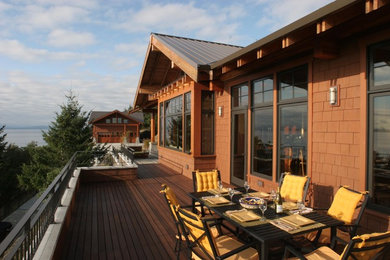 Example of a mid-sized classic backyard deck design in Seattle with no cover