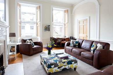 This is an example of a traditional living room in Edinburgh with medium hardwood floors and no tv.