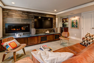 Mid-sized contemporary enclosed family room in Columbus with grey walls, concrete floors, a ribbon fireplace, a metal fireplace surround and a wall-mounted tv.