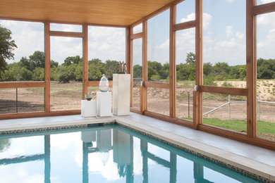 Inspiration for a large modern indoor concrete and rectangular pool remodel in Austin