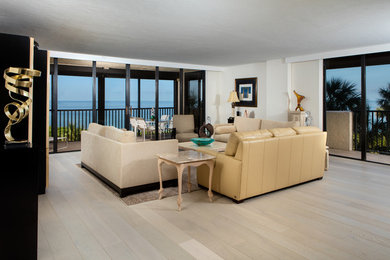 Inspiration for a mid-sized contemporary open concept light wood floor living room remodel in Other with yellow walls, no fireplace and a concealed tv