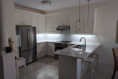 Inspiration for a contemporary kitchen remodel in Toronto with shaker cabinets and white cabinets