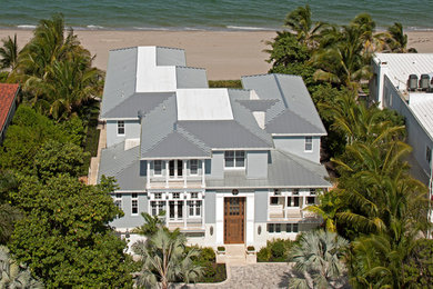 Inspiration for an expansive beach style two-storey stucco blue exterior in Miami.