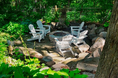 Patio - contemporary backyard stone patio idea in Minneapolis with a fire pit and no cover
