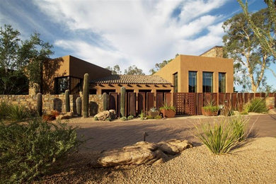 Large modern beige one-story stucco flat roof idea in Phoenix