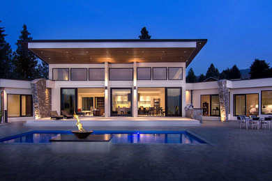 Huge contemporary beige two-story stucco exterior home idea in Vancouver
