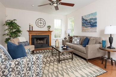 Inspiration for a mid-sized timeless open concept medium tone wood floor family room remodel in Philadelphia with white walls