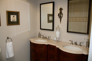 Inspiration for a mid-sized mediterranean 3/4 beige tile and ceramic tile bathroom remodel in Philadelphia with furniture-like cabinets, dark wood cabinets, beige walls, an undermount sink and marble countertops