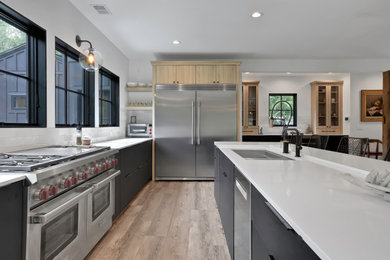Example of a large trendy l-shaped open concept kitchen design in New York with an undermount sink, flat-panel cabinets, black cabinets, quartz countertops, white backsplash, ceramic backsplash, stainless steel appliances, an island and white countertops