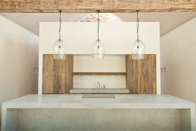 Design ideas for a rustic galley kitchen in Other with an integrated sink, medium wood cabinets, concrete worktops and an island.