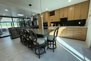 Example of a large 1950s porcelain tile and gray floor enclosed kitchen design in Phoenix with an undermount sink, flat-panel cabinets, light wood cabinets, quartz countertops, green backsplash, ceramic backsplash, stainless steel appliances, two islands and green countertops
