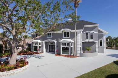Example of a large trendy gray two-story house exterior design in Orlando