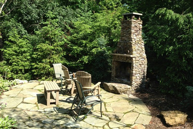 Backyard patio photo in New York with a fire pit and no cover