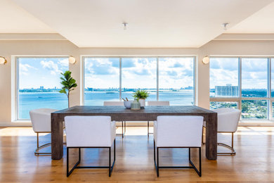 Inspiration for a large contemporary brown floor dining room remodel in Miami with white walls and no fireplace