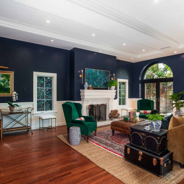 Traditional Living Room with Navy Walls, Fireplace, and Arched Glass Doors