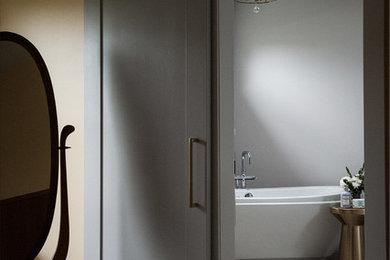 Example of a mid-sized transitional master gray tile and porcelain tile porcelain tile and multicolored floor bathroom design in Chicago with shaker cabinets, gray cabinets, a two-piece toilet, gray walls, an undermount sink, quartz countertops, a hinged shower door and white countertops