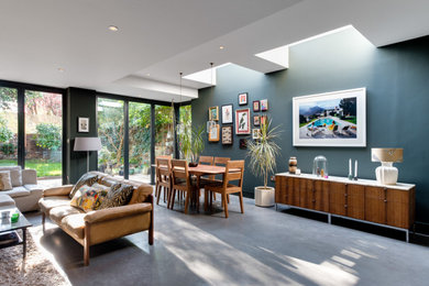 Mid-sized modern open concept living room in London with concrete floors and grey floor.