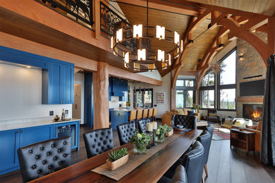 Large mountain style dark wood floor and brown floor great room photo in Vancouver with white walls