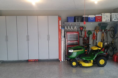 Example of a large transitional attached two-car garage design in Omaha