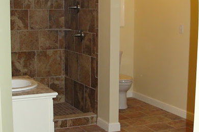 Inspiration for a mid-sized 3/4 ceramic tile ceramic tile alcove shower remodel in Other with a drop-in sink, white cabinets, granite countertops, a one-piece toilet and beige walls