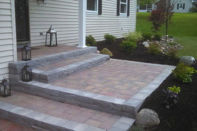 Photo of a small traditional partial sun front yard stone landscaping in New York.