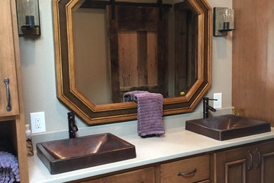 Bathroom - large transitional master multicolored tile and stone tile ceramic tile bathroom idea in Other with furniture-like cabinets, medium tone wood cabinets, beige walls, a drop-in sink and solid surface countertops