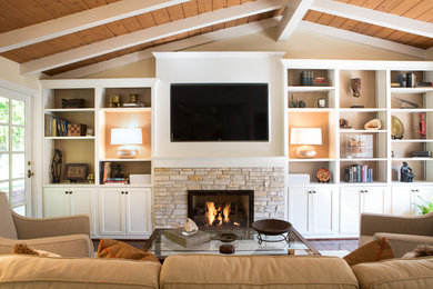 Design ideas for a mid-sized transitional open concept living room in Los Angeles with beige walls, medium hardwood floors, a standard fireplace, a stone fireplace surround and a built-in media wall.