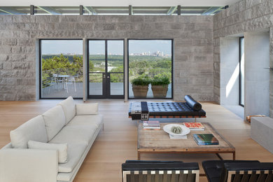 Living room - large modern open concept and formal light wood floor living room idea in Austin with a tv stand and gray walls
