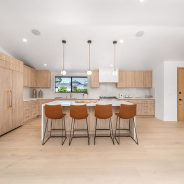 Kitchen Island Seating Under Three Brass Pendants