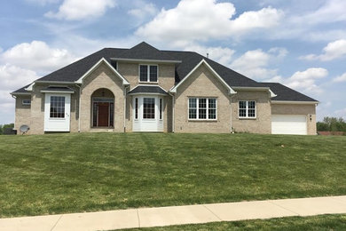 Large elegant beige two-story wood gable roof photo in Indianapolis