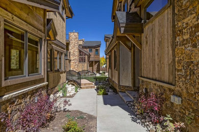 This is an example of a mid-sized rustic drought-tolerant and partial sun courtyard concrete paver garden path in Denver for spring.