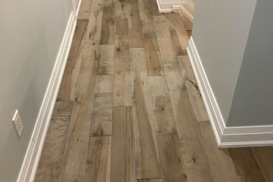 Inspiration for a large timeless medium tone wood floor and brown floor hallway remodel in Ottawa with beige walls