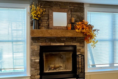Family room - traditional family room idea in Baltimore with a standard fireplace and a stacked stone fireplace
