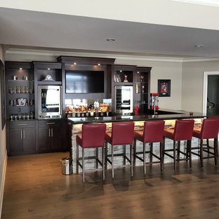 Design ideas for a medium sized classic fully buried basement in Ottawa with grey walls, medium hardwood flooring and brown floors.