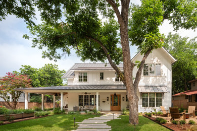 Example of a mid-sized farmhouse white two-story concrete fiberboard and clapboard exterior home design in Austin with a metal roof and a gray roof