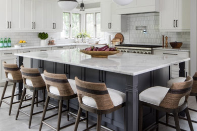 Medium sized traditional l-shaped enclosed kitchen in New York with a submerged sink, shaker cabinets, white cabinets, quartz worktops, white splashback, marble splashback, integrated appliances, ceramic flooring, an island, grey floors and white worktops.