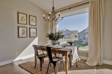 Kitchen/dining room combo - mid-sized cottage medium tone wood floor and beige floor kitchen/dining room combo idea in Wichita with gray walls