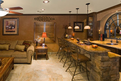 Seated home bar - large rustic galley beige floor seated home bar idea in Phoenix with an undermount sink, recessed-panel cabinets, dark wood cabinets, soapstone countertops, beige backsplash, stone slab backsplash and beige countertops